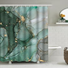 a shower curtain with green and gold marble design on it, in a white bathroom