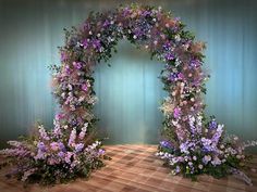 an arch made out of flowers and greenery