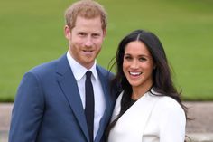 prince harry and his wife are smiling for the camera