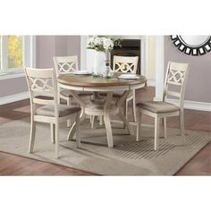 a dining room table with four chairs around it