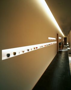 there are many bowls on the wall in this room, and one is lit up