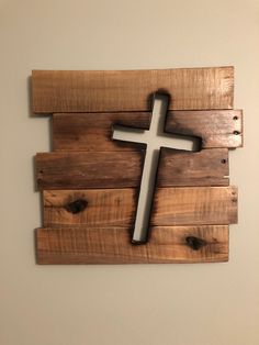 a wooden cross hanging on the wall