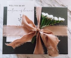 a card with a ribbon tied around it