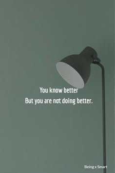 a black lamp with a white quote on the wall above it that says, you know better but you are not doing better