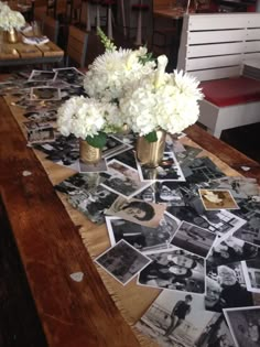 flowers and pictures are arranged on the table