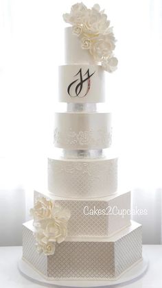 a white wedding cake with flowers on top