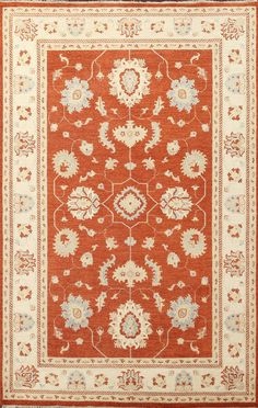 an orange rug with white and blue flowers on the bottom, in front of a red background