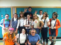 a group of young people standing next to each other in front of blue lockers