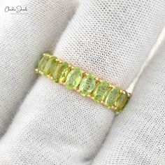 Description Discover timeless elegance with our Eternity Gemstone Ring featuring 5x3mm Peridot stones, set in a handcrafted 14k Yellow Gold stack band. Perfect for stacking or wearing solo, this handmade piece is a true representation of beauty and craftsmanship. Ideal as a statement ring or a special gift for any occasion. Product Details SKU CJ R 1336 P YG NP Product dimension 23.33mm x 4.97mm Metal 14k Yellow Gold Birthstone August Peridot Details Stone size 5x3mm Quality AAA Stone pieces 20 Peridot Band Ring, Luxury Peridot Three Stone Rings, Luxury Peridot Gemstone Ring, Peridot Promise Ring, Peridot Ring Engagement, Peridot Wedding Band, Peridot Ring Gold, Peridot Rings, Gemstone Wedding Ring