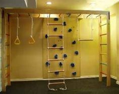 an empty room with ladders and blue balls on the wall