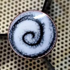 a blue and white plate with a spiral design on it