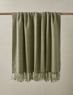 a green blanket hanging on a clothes line