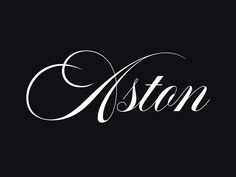 the word aston written in cursive writing on a black background with white ink