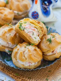 several rolls with meat and cheese are on a plate