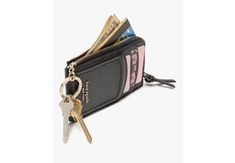 a black wallet with two keys hanging from it's front pocket and some credit cards sticking out of it