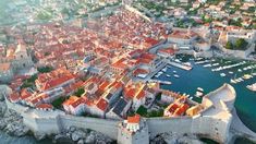 an aerial view of a city with boats in the water and lots of buildings around it