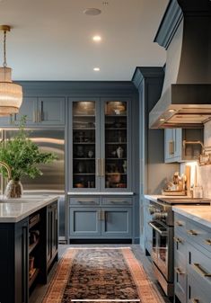 a large kitchen with blue cabinets and an area rug on the floor in front of it