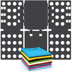 a stack of different colored towels next to a black and white wall with polka dots on it