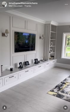 a living room filled with furniture and a flat screen tv mounted to the side of a wall