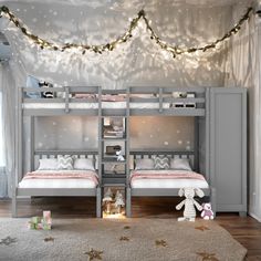 two children's bunk beds in a bedroom decorated with christmas lights and garlands