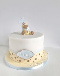 a white cake with a giraffe on top and the number one on it