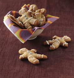 some cookies are sitting in a bowl on a table next to other small pieces of food