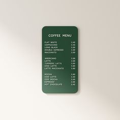 a green coffee menu on a white wall