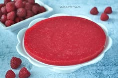 raspberry cheesecake batter in a bowl with fresh raspberries around it