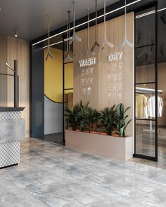 the entrance to a store with plants in it