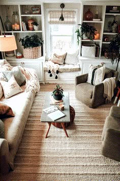 a living room with two couches and a coffee table in front of a window