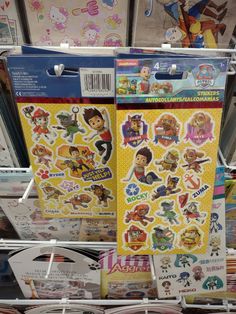 various stickers are on display in a toy store, with other items behind them