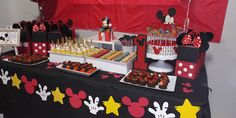 a table topped with lots of cakes and cupcakes