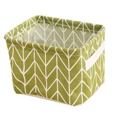 a green and white storage box with geometric designs on the front, in an open position