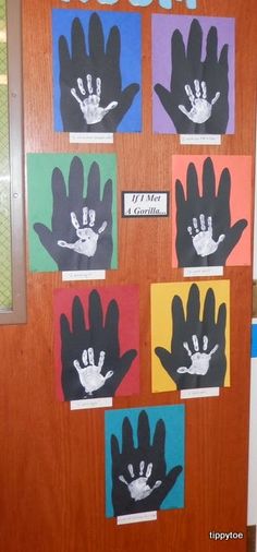 a door decorated with handprints and the word boom written on it in different colors