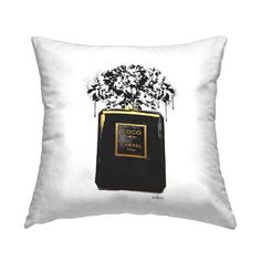 a black and white pillow with an image of a chanel perfume bottle on it