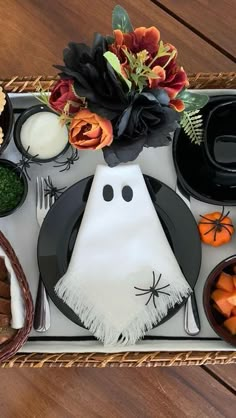 a tray filled with halloween food on top of a wooden table