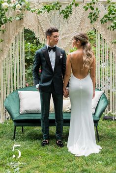 a man and woman standing next to each other in front of an outdoor ceremony area