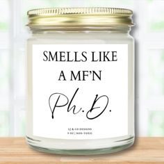 a glass jar with the words smells like a mmfn ph d on it