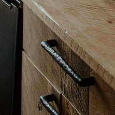 a kitchen counter with two drawers and an oven in the background