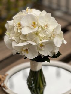 a bouquet of white flowers sitting on top of a table