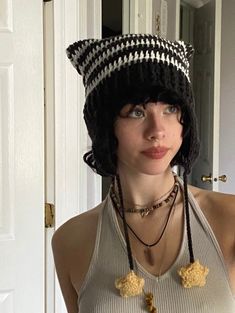 a woman wearing a black and white knitted hat