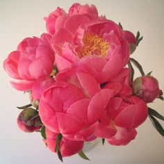 a bouquet of pink flowers sitting on top of a table