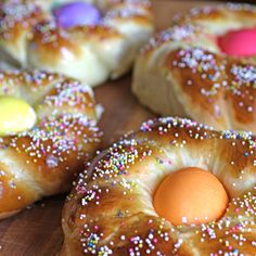 there are many donuts with sprinkles and an egg in the middle