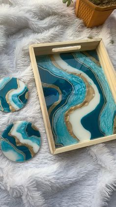 blue and gold marbled coasters on white furnishing next to a tray