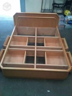 an open wooden box sitting on top of a floor