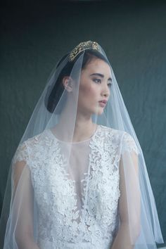 a woman in a wedding dress with a veil on her head