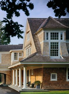 a large brown house with white trim and windows