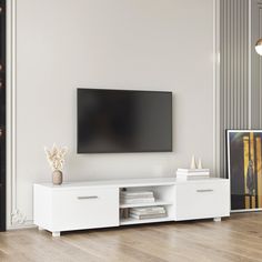 a flat screen tv sitting on top of a white entertainment center in a living room