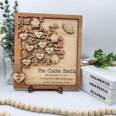 a wooden plaque with the names and hearts on it, surrounded by other wood decorations