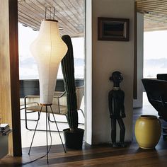 a living room filled with furniture and a tall lamp